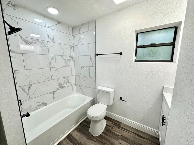 2527 Dons Pl, Lakeland, FL 33801 - bathroom with toilet, wood finished floors, vanity, washtub / shower combination, and baseboards