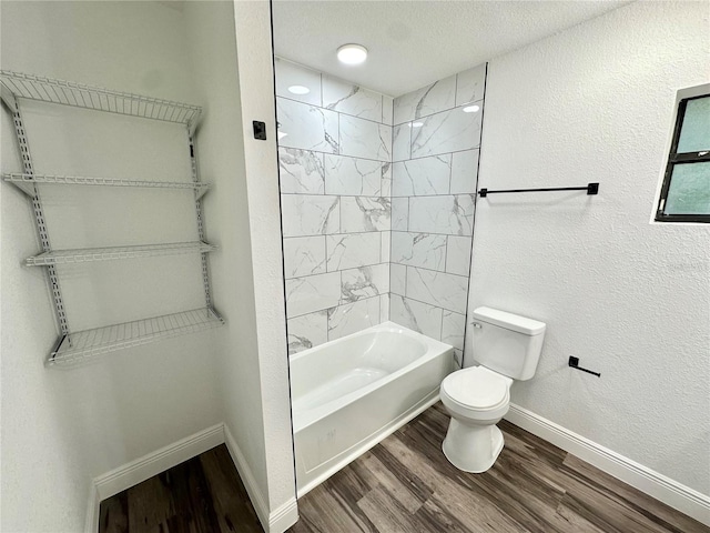 2527 Dons Pl, Lakeland, FL 33801 - full bathroom featuring wood finished floors, toilet, baseboards,  shower combination, and a textured ceiling