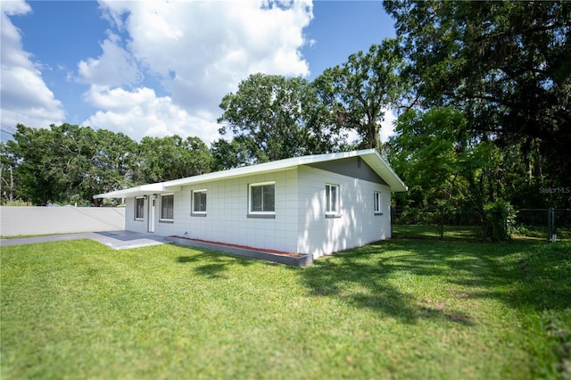 2527 Dons Pl, Lakeland, FL 33801 - back of house featuring a patio and view of scattered trees