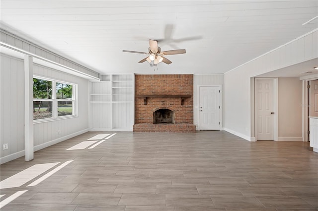 1502 Edgewater Beach Dr, Lakeland, FL 33805 - unfurnished living room with a brick fireplace, baseboards, wood finished floors, and ceiling fan