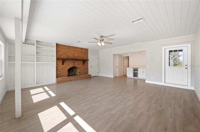 1502 Edgewater Beach Dr, Lakeland, FL 33805 - unfurnished living room featuring a fireplace, a ceiling fan, wooden ceiling, light wood finished floors, and baseboards