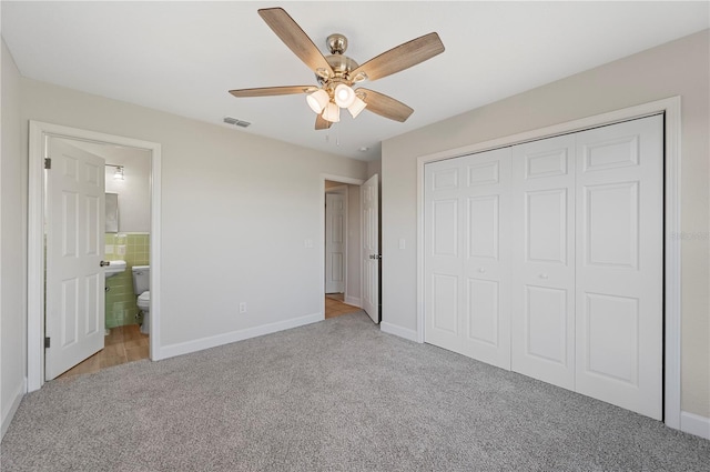1502 Edgewater Beach Dr, Lakeland, FL 33805 - unfurnished bedroom with visible vents, a closet, ceiling fan, connected bathroom, and light carpet