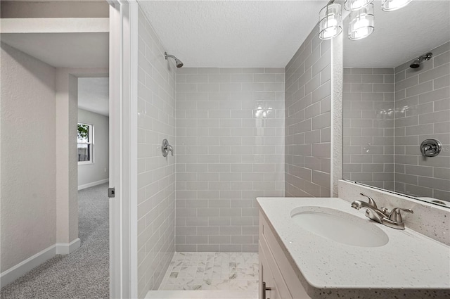 1502 Edgewater Beach Dr, Lakeland, FL 33805 - bathroom with baseboards, vanity, a textured ceiling, and a tile shower