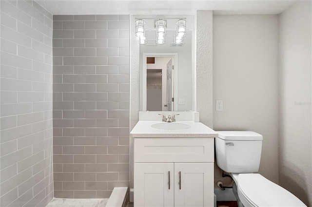 1502 Edgewater Beach Dr, Lakeland, FL 33805 - bathroom featuring vanity, a tile shower, and toilet