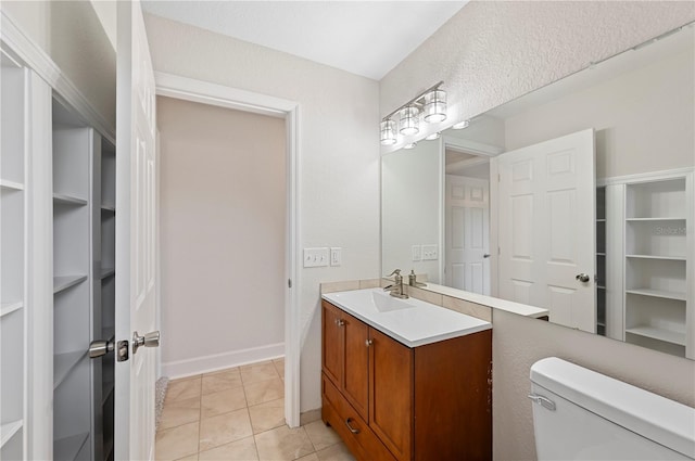 1502 Edgewater Beach Dr, Lakeland, FL 33805 - bathroom featuring tile patterned flooring, toilet, vanity, and baseboards