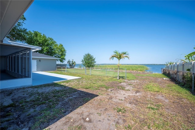 1502 Edgewater Beach Dr, Lakeland, FL 33805 - view of yard with a water view, fence, a patio, and a sunroom