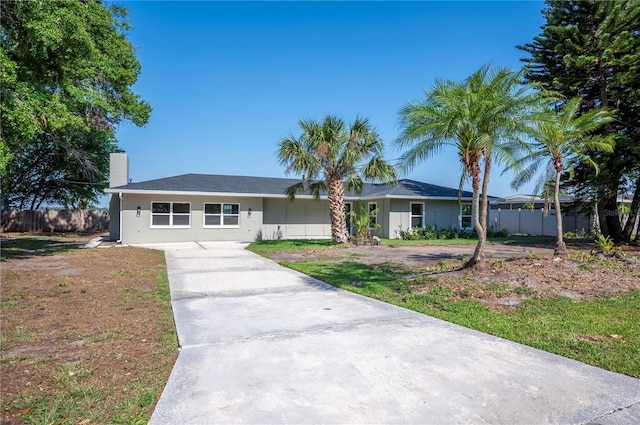 1502 Edgewater Beach Dr, Lakeland, FL 33805 - ranch-style house featuring a chimney, concrete driveway, and fence