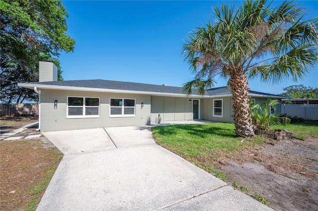 1502 Edgewater Beach Dr, Lakeland, FL 33805 - single story home featuring a chimney, driveway, a front yard, and fence