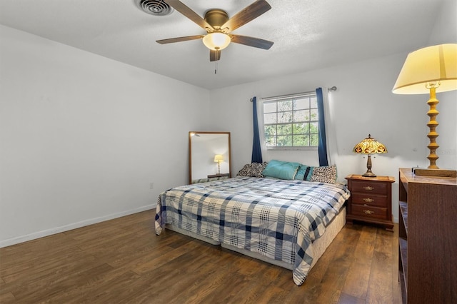 bedroom with visible vents, baseboards, a ceiling fan, and wood finished floors