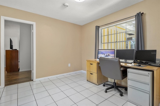 home office with light tile patterned floors and baseboards