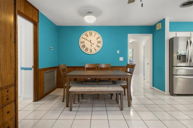dining space with ceiling fan, visible vents, and light tile patterned floors