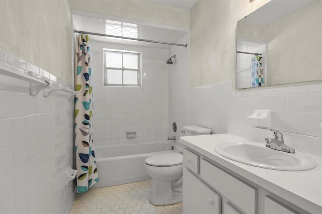full bath featuring toilet, tile walls, shower / bathtub combination with curtain, vanity, and tile patterned flooring