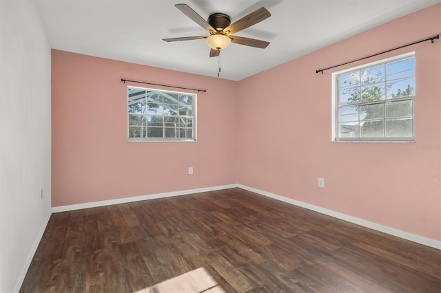 unfurnished room with dark wood-type flooring, baseboards, and a ceiling fan