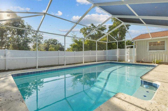 view of pool with a fenced backyard, a fenced in pool, and a lanai