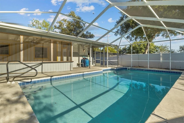 view of pool with a patio, a fenced in pool, fence, and glass enclosure