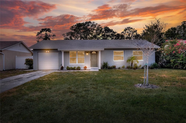 13032 Cumberland Dr, Largo, FL 33773 - view of front facade featuring an attached garage, a front lawn, driveway, and stucco siding