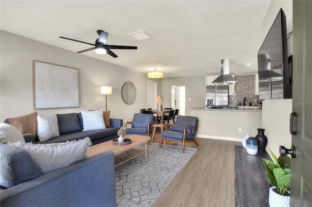 13032 Cumberland Dr, Largo, FL 33773 - living area with wood finished floors, a textured ceiling, and ceiling fan