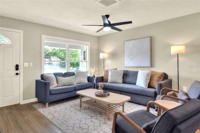 13032 Cumberland Dr, Largo, FL 33773 - living area featuring baseboards, wood finished floors, visible vents, and a ceiling fan