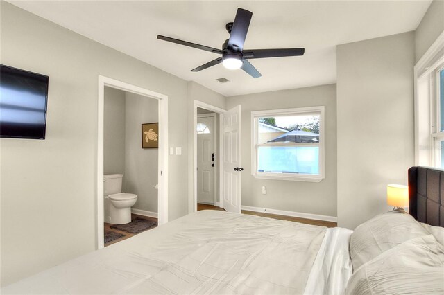 13032 Cumberland Dr, Largo, FL 33773 - bedroom with ceiling fan, visible vents, baseboards, and ensuite bathroom
