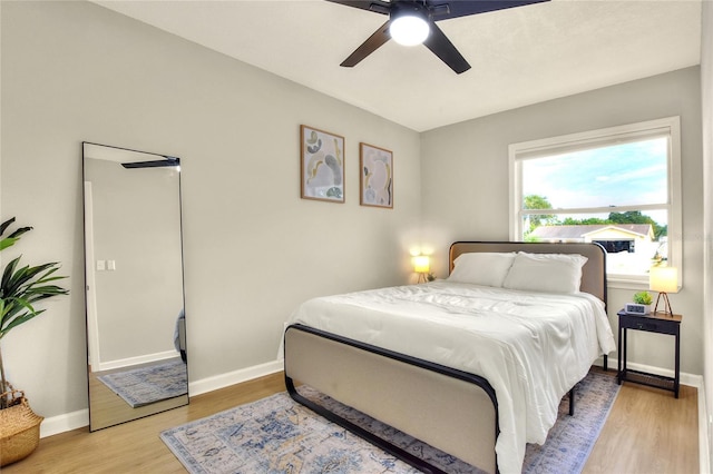 13032 Cumberland Dr, Largo, FL 33773 - bedroom with light wood-style flooring, baseboards, and a ceiling fan