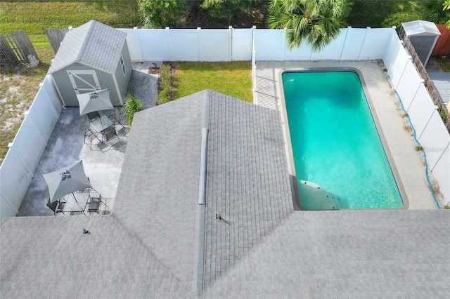 13032 Cumberland Dr, Largo, FL 33773 - view of pool with a patio area, a fenced backyard, an outdoor structure, a fenced in pool, and a storage unit
