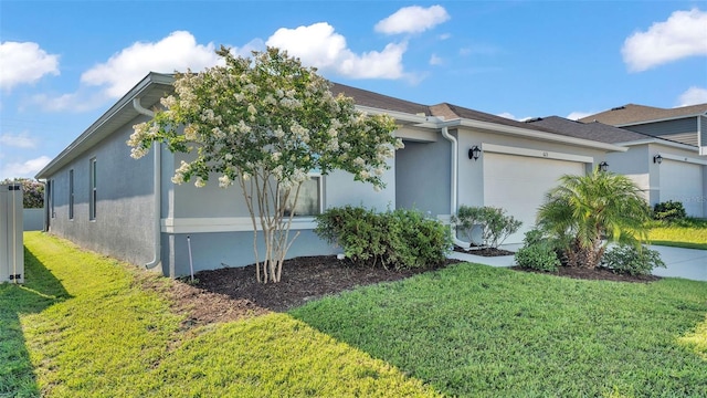 613 Sarner Pass Way, Winter Haven, FL 33881 - view of property exterior featuring a yard, an attached garage, and stucco siding