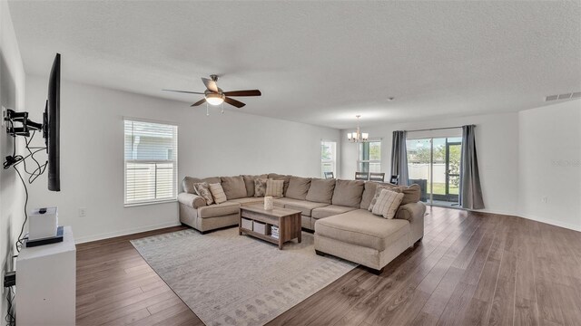 613 Sarner Pass Way, Winter Haven, FL 33881 - living area featuring a chandelier, wood finished floors, a textured ceiling, and ceiling fan
