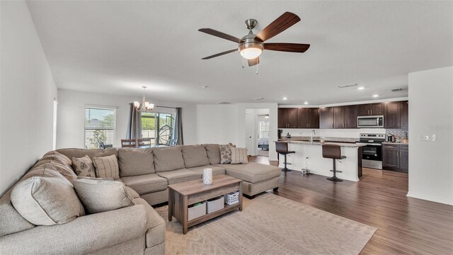 613 Sarner Pass Way, Winter Haven, FL 33881 - living area with a chandelier, light wood-style floors, ceiling fan, and recessed lighting