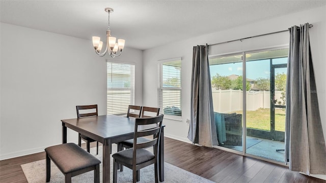613 Sarner Pass Way, Winter Haven, FL 33881 - dining area featuring a chandelier, dark wood-style flooring, and plenty of natural light