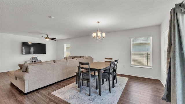 613 Sarner Pass Way, Winter Haven, FL 33881 - dining room featuring healthy amount of natural light, a chandelier, ceiling fan, dark wood-style flooring, and a textured ceiling