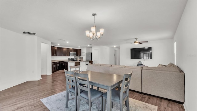 613 Sarner Pass Way, Winter Haven, FL 33881 - dining area with a chandelier, a ceiling fan, wood finished floors, and recessed lighting