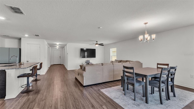 613 Sarner Pass Way, Winter Haven, FL 33881 - dining area featuring a textured ceiling, ceiling fan, dark wood-style floors, a chandelier, and recessed lighting