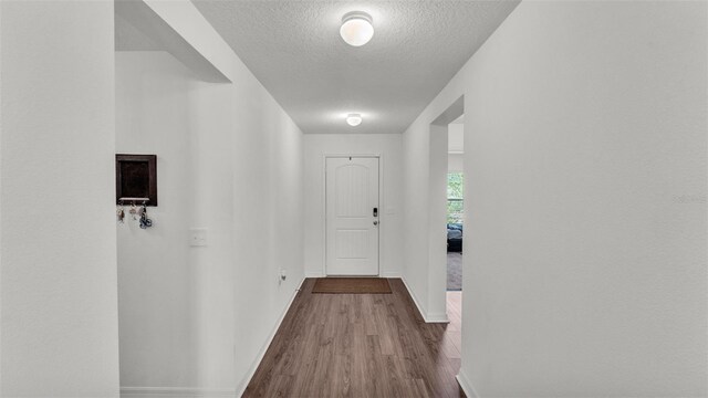 613 Sarner Pass Way, Winter Haven, FL 33881 - hallway with a textured ceiling and dark wood finished floors