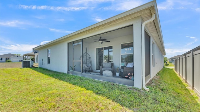 613 Sarner Pass Way, Winter Haven, FL 33881 - rear view of property featuring a lawn, a ceiling fan, a sunroom, and stucco siding
