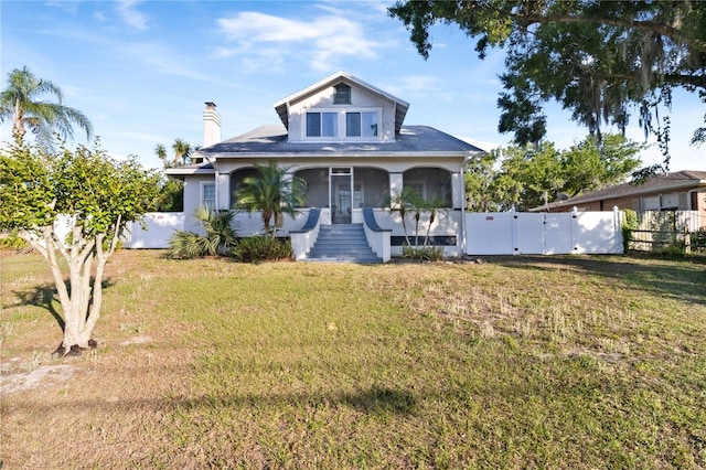 bungalow-style home featuring fence, a chimney, a gate, and a front yard