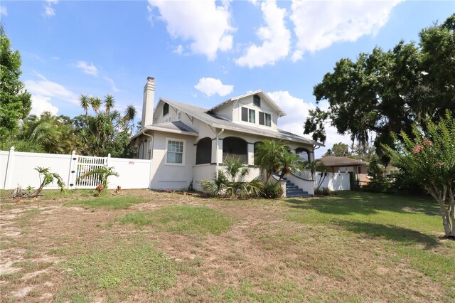 934 Lake Elbert Dr SE, Winter Haven, FL 33880 - view of home's exterior with a gate and a chimney
