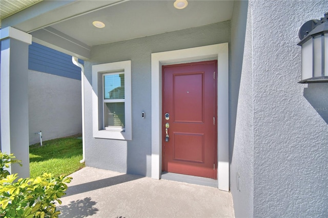property entrance featuring stucco siding