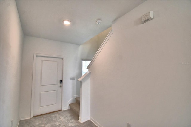 interior space featuring stairway and baseboards