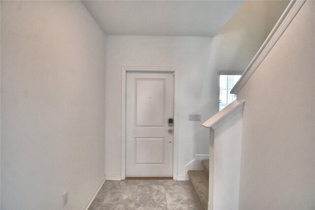 interior space featuring baseboards and stairs