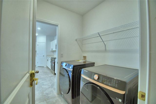 laundry room featuring separate washer and dryer and laundry area