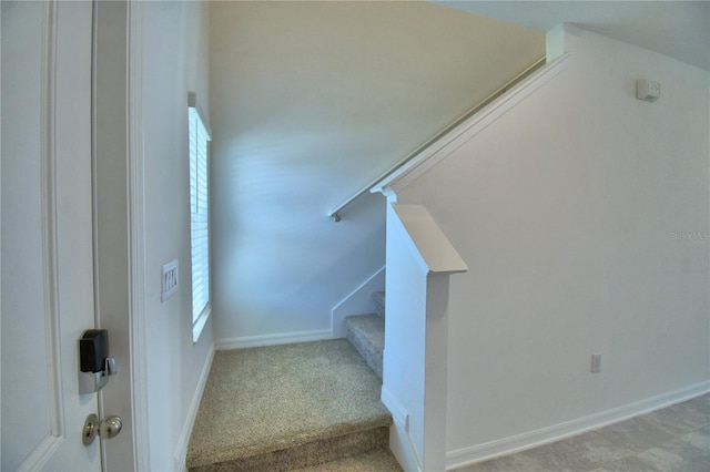staircase featuring baseboards