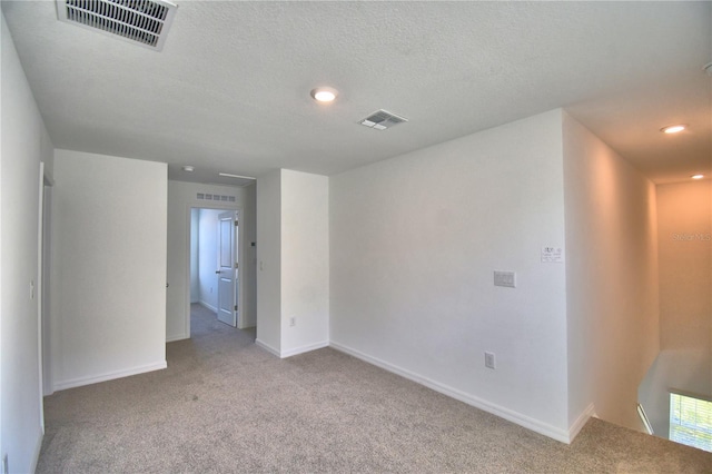 spare room with visible vents and carpet