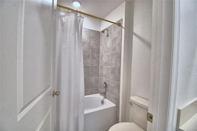bathroom featuring shower / bath combo and toilet