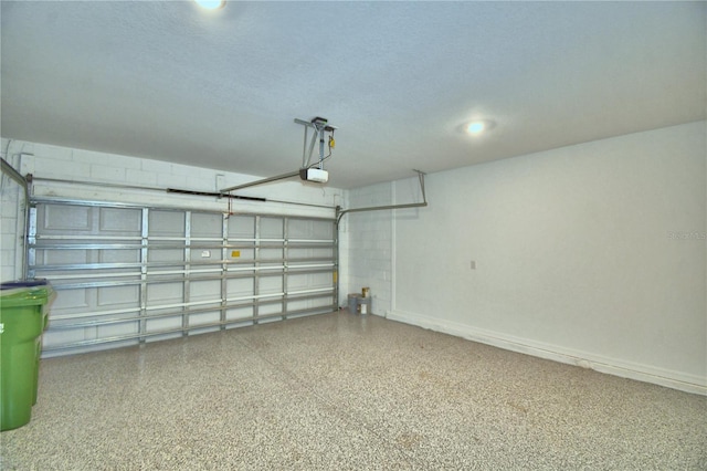 garage featuring baseboards and a garage door opener
