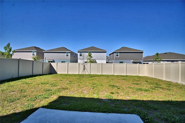 view of yard featuring a residential view and a fenced backyard
