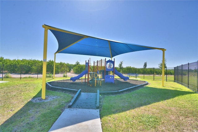 community playground featuring fence and a lawn