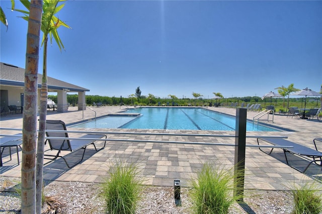 pool featuring a patio and fence