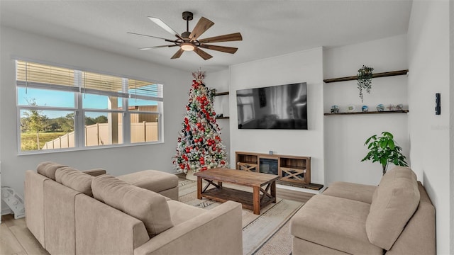 living room featuring a ceiling fan and light wood-style flooring