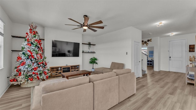 living area with light wood finished floors and ceiling fan