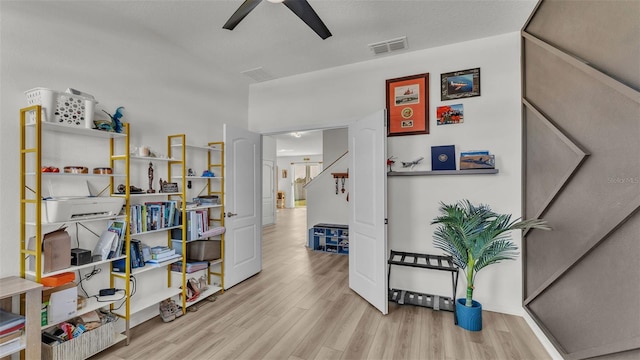 interior space with wood finished floors and visible vents